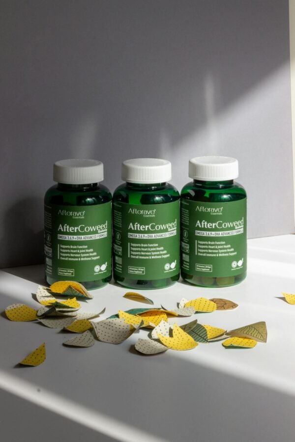 Three green supplement bottles with leaves on a white surface, indoors.